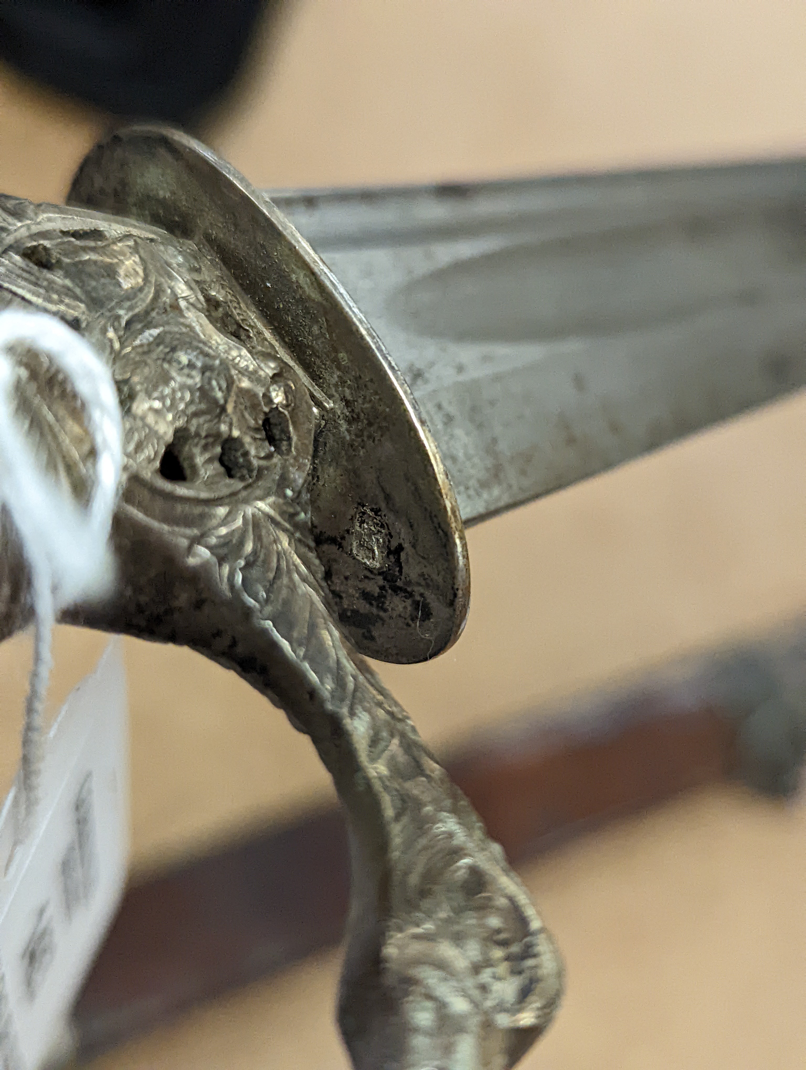 An English silver hilt hanger c.1770, London, maker M.B (year letter indistinct) eagle head pommel and crosspiece finials, spiral carved, green-stained ivory grip, curved fullered blade 63cms, retaining the top of its si